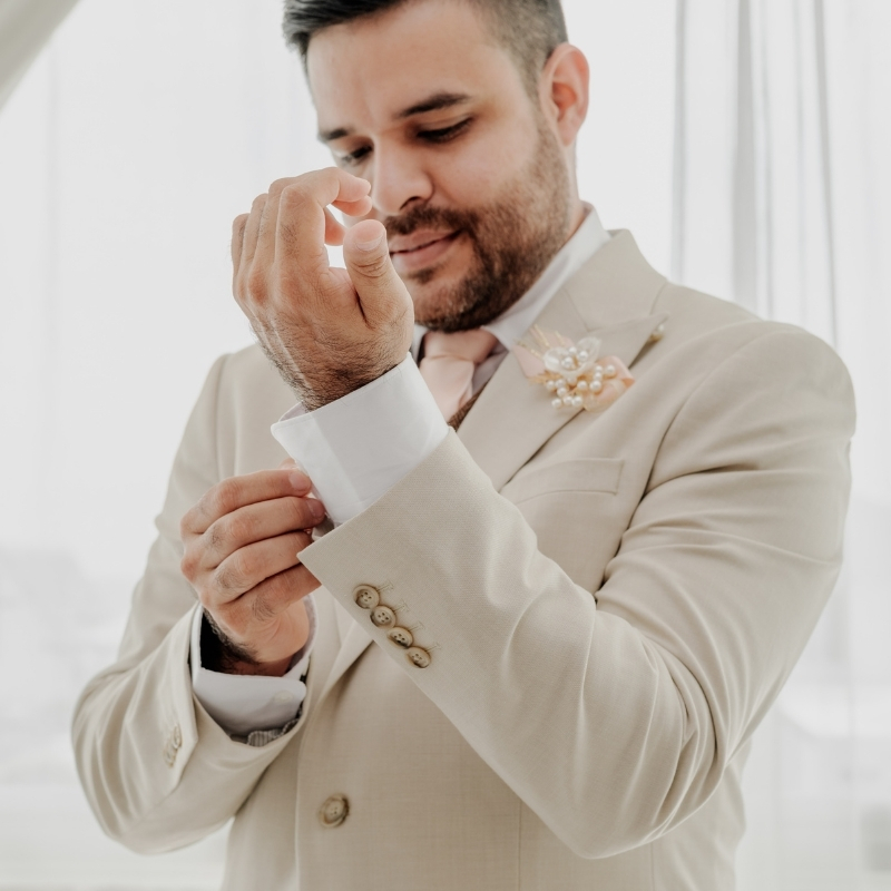 Detalle de novio tranquilo y elegante durante su boda en General Villamil Playas.